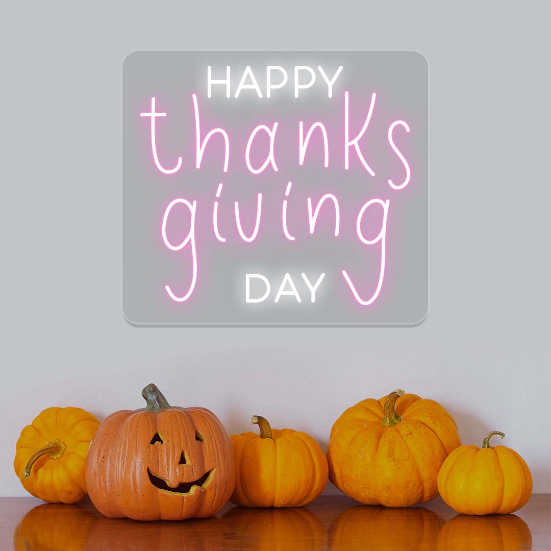 Happy Thanksgiving Day neon sign in pink and white with pumpkins, festive autumn wall decor