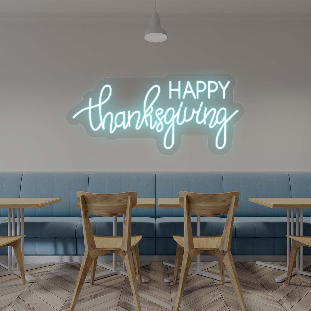Happy Thanksgiving neon sign in ice blue script on cafe wall