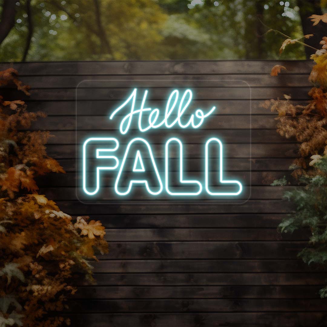 Hello Fall neon sign in iceblue on dark wood outdoor wall with autumn leaves