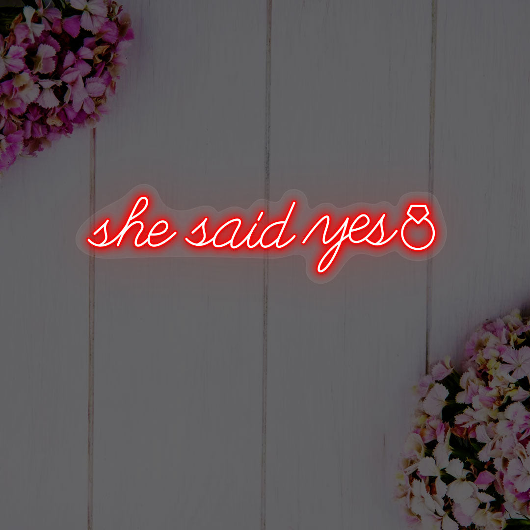 red she said yes wedding neon sign mounted on a wall