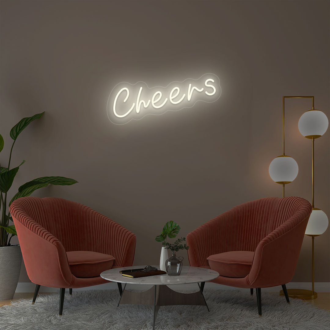 Cheers warmwhite neon sign wall decor in modern lounge with velvet chairs and gold floor lamp