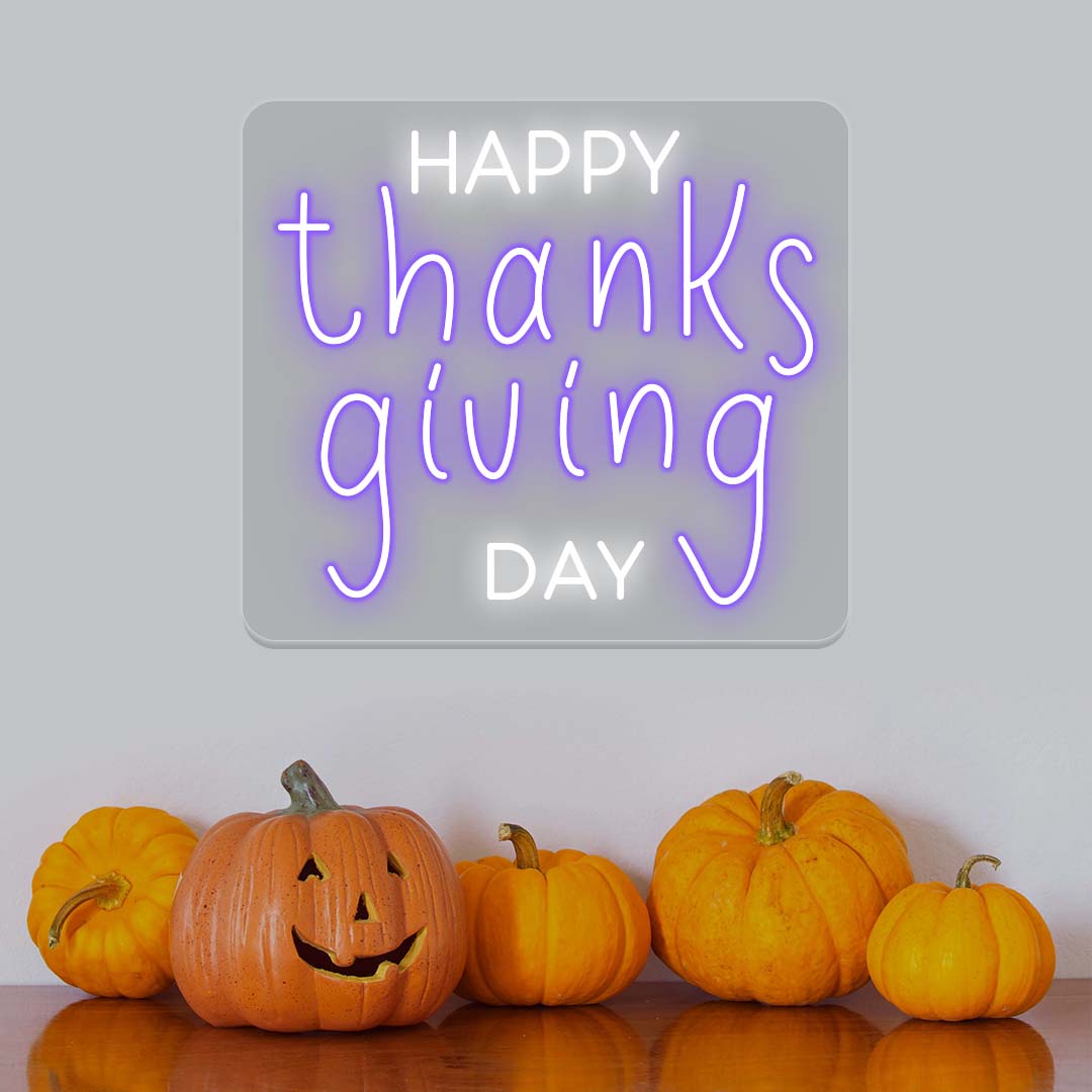 Happy Thanksgiving Day neon sign in purple and white with pumpkins, festive autumn wall decor