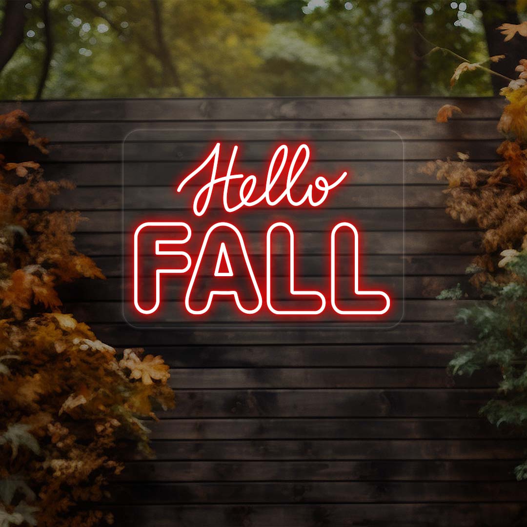 Hello Fall neon sign in red on dark wood outdoor wall with autumn leaves