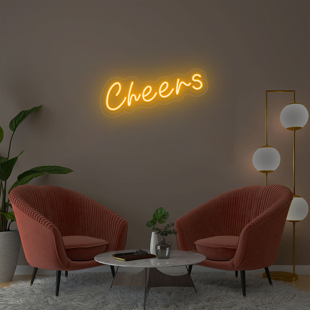 Cheers orange neon sign wall decor in modern lounge with velvet chairs and gold floor lamp