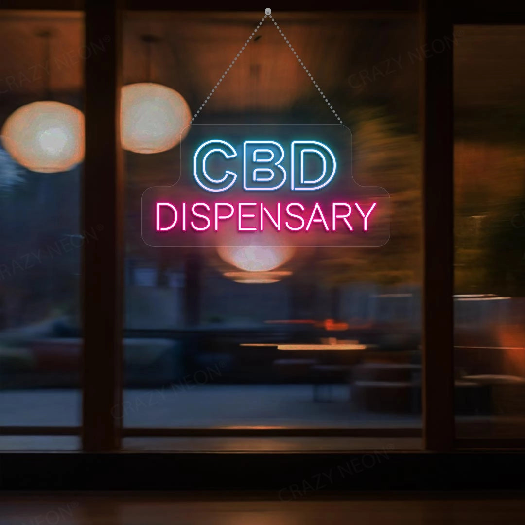 A glowing neon sign reads CBD DISPENSARY with CBD in blue and DISPENSARY in pink hanging against a large window