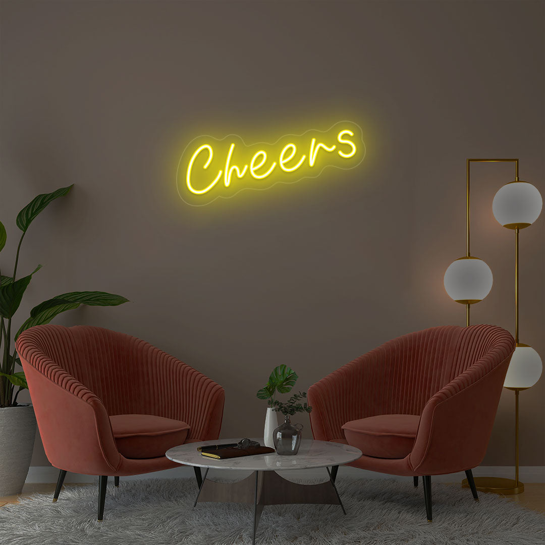 Cheers yellow neon sign wall decor in modern lounge with velvet chairs and gold floor lamp