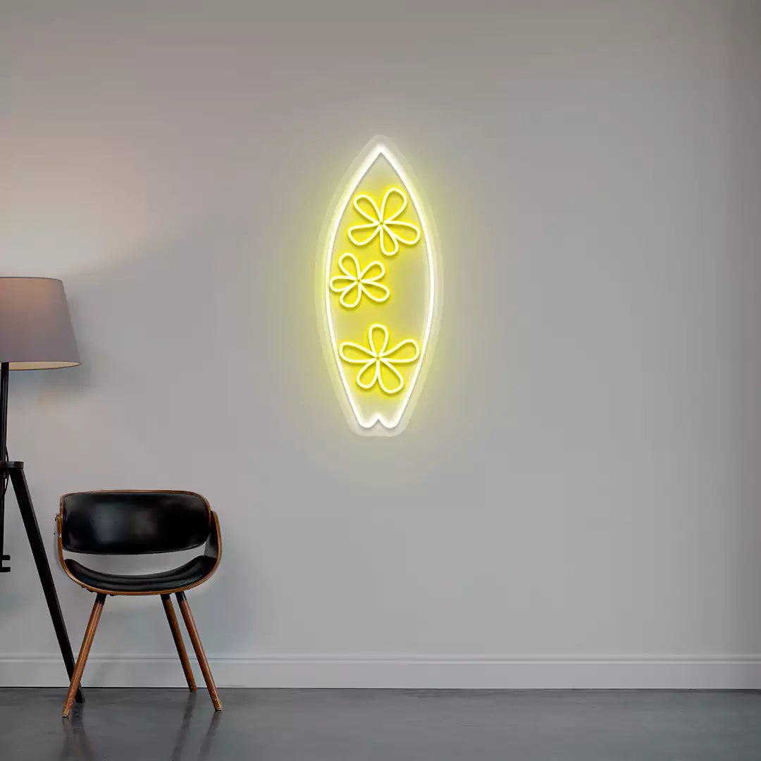 yellow and white floral surfboard neon sign mounted on a wall