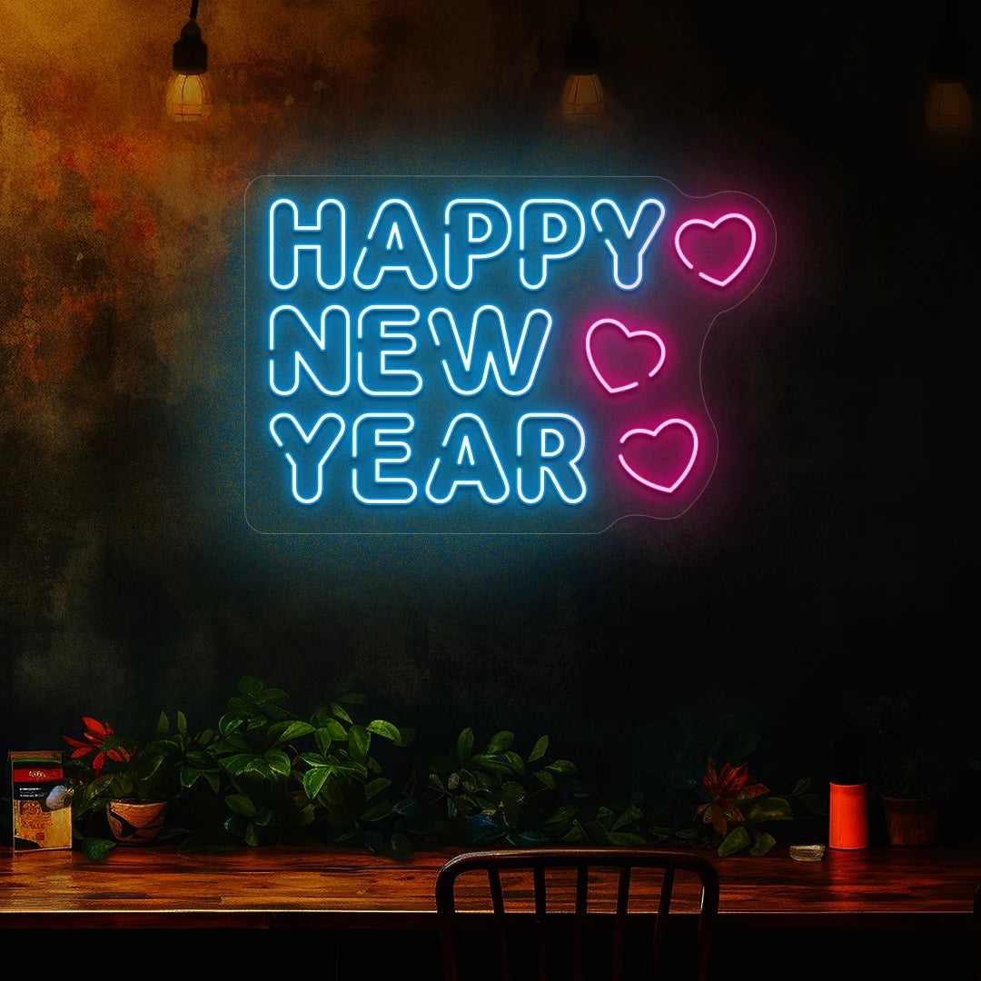 Happy New Year neon sign in ice blue and pink heart lights mounted on a dark wall