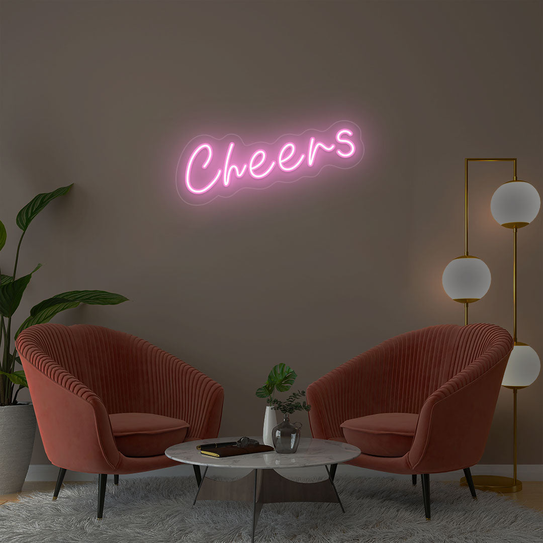 Cheers pink neon sign wall decor in modern lounge with velvet chairs and gold floor lamp