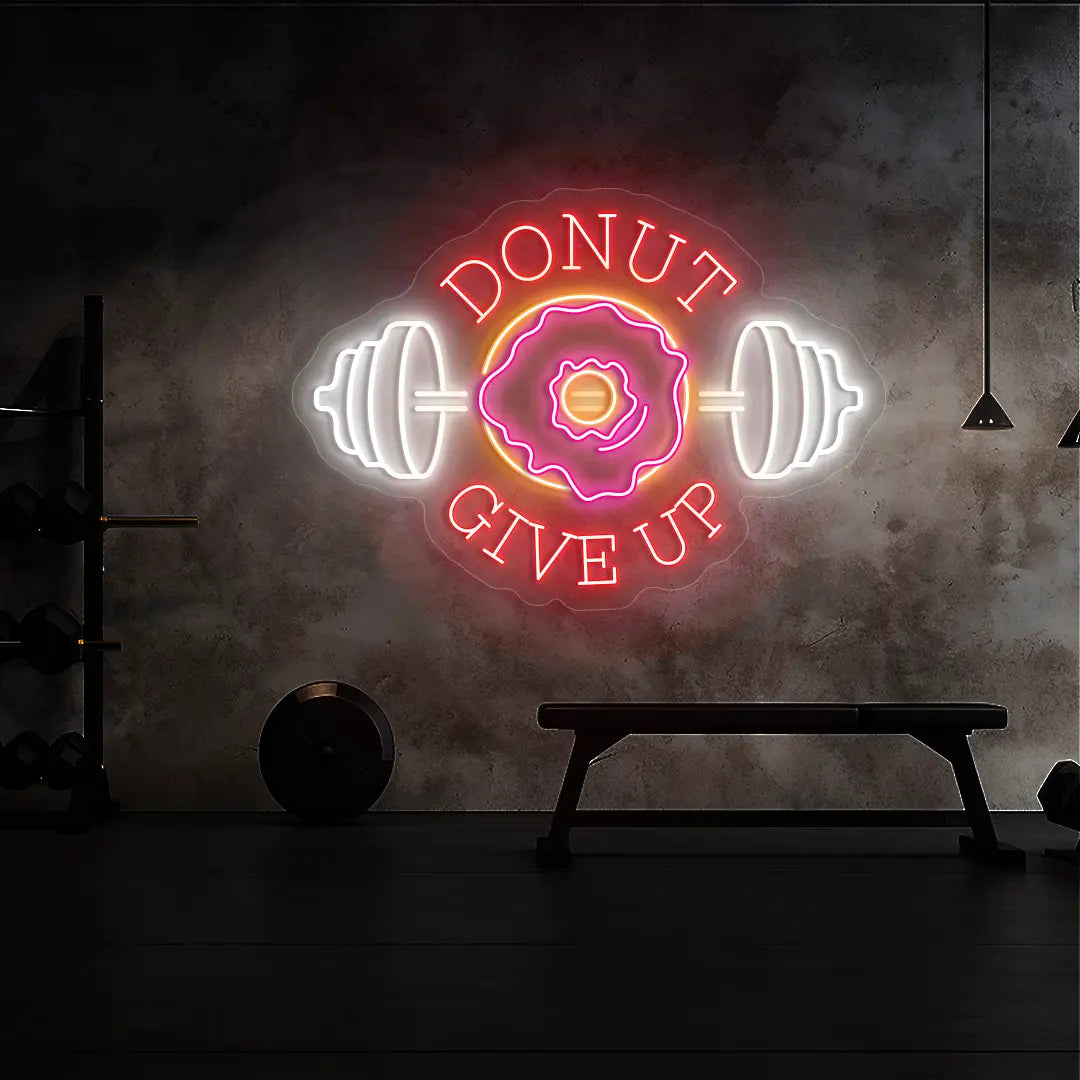 multi color donut give up gym neon sign mounted on a wall