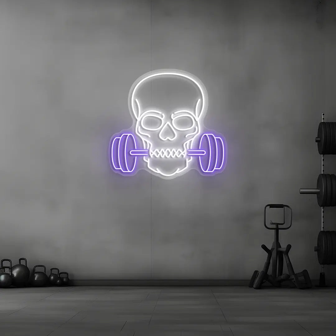 purple and white skull barbell gym neon sign mounted on a wall
