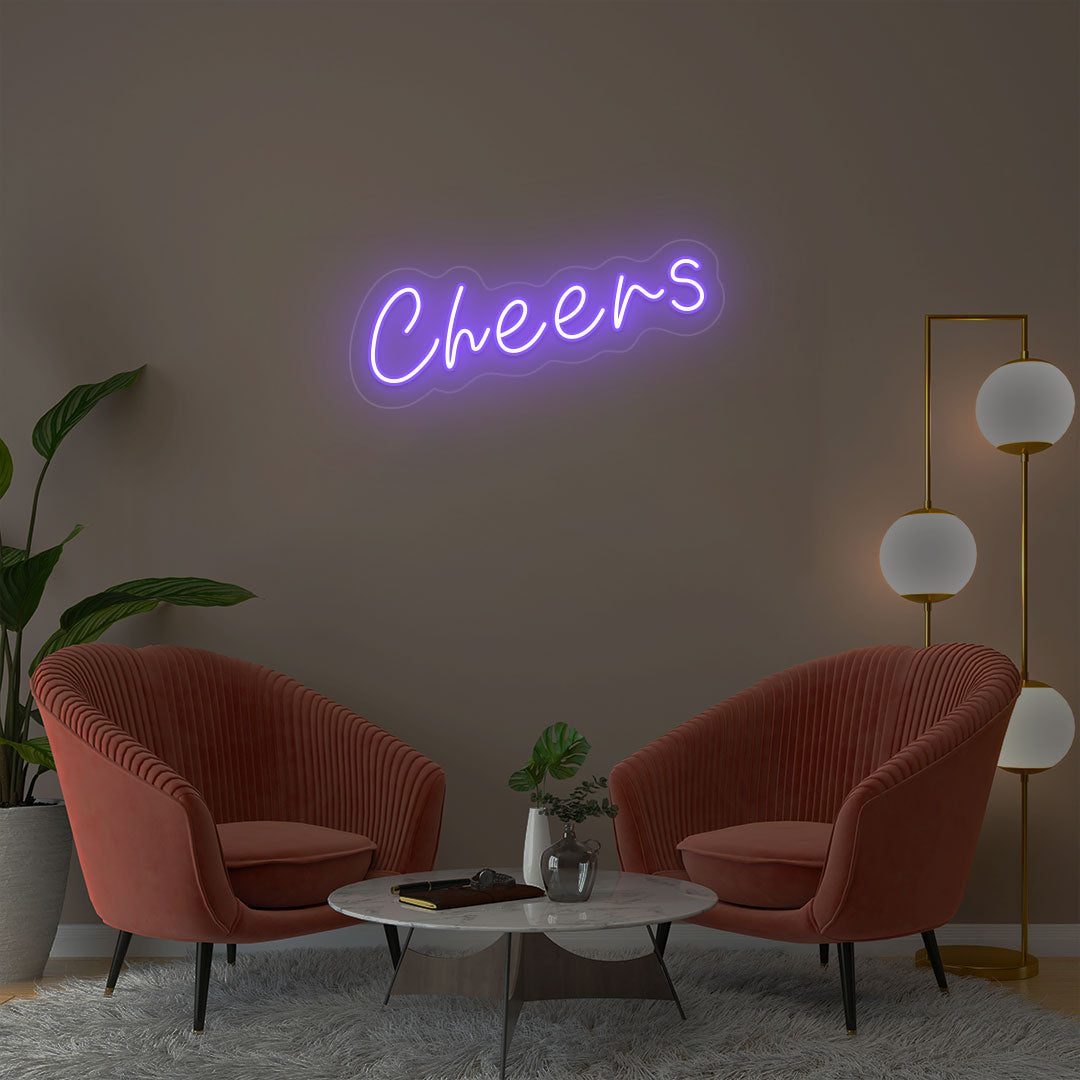 Cheers purple neon sign wall decor in modern lounge with velvet chairs and gold floor lamp