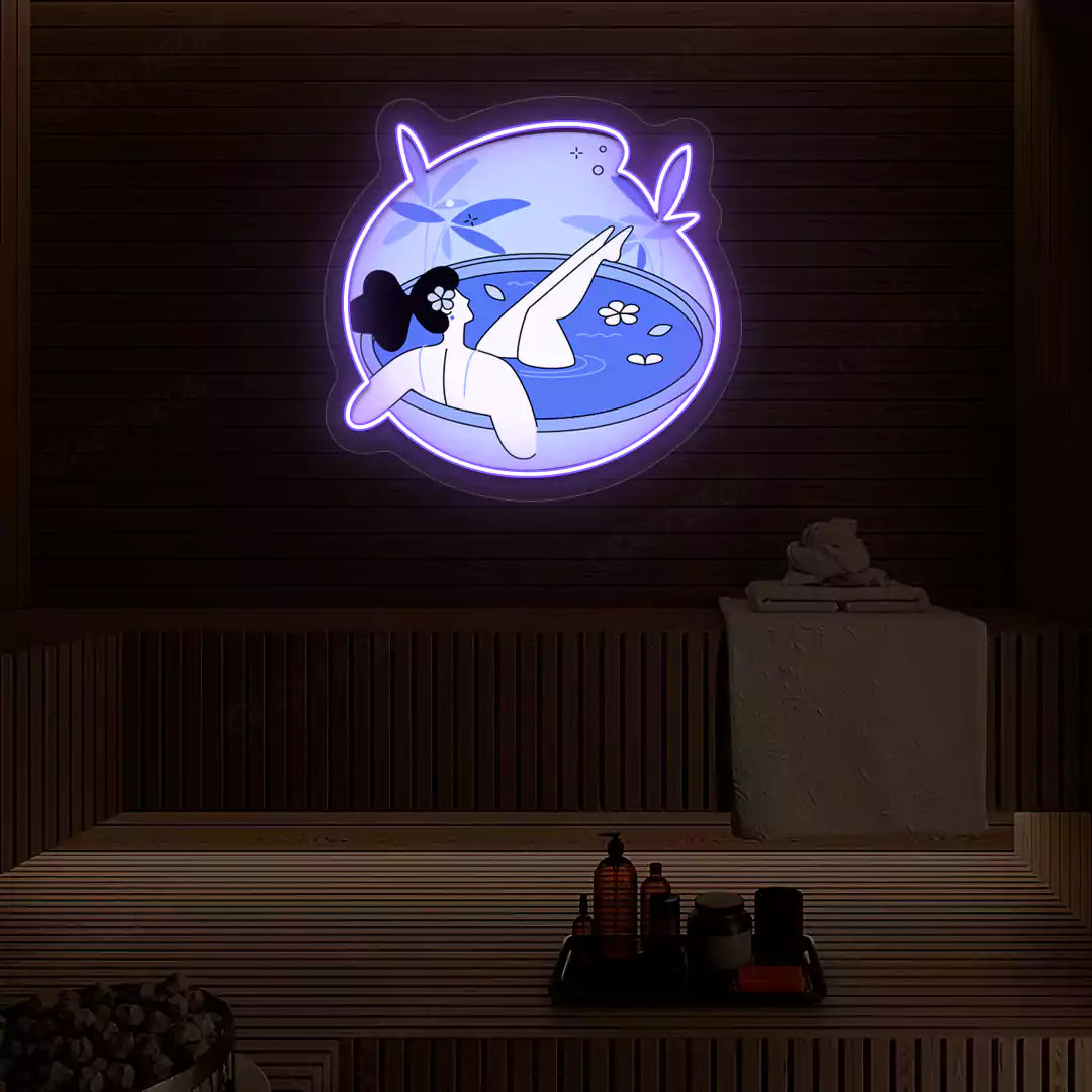 Blue Blossom Bath Neon Artwork lighting up in purple color on a wooden spa wall