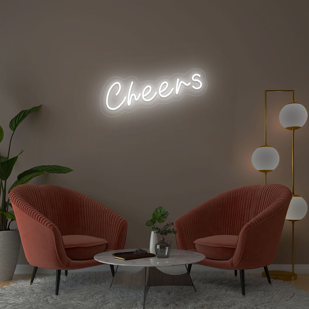 Cheers white neon sign wall decor in modern lounge with velvet chairs and gold floor lamp