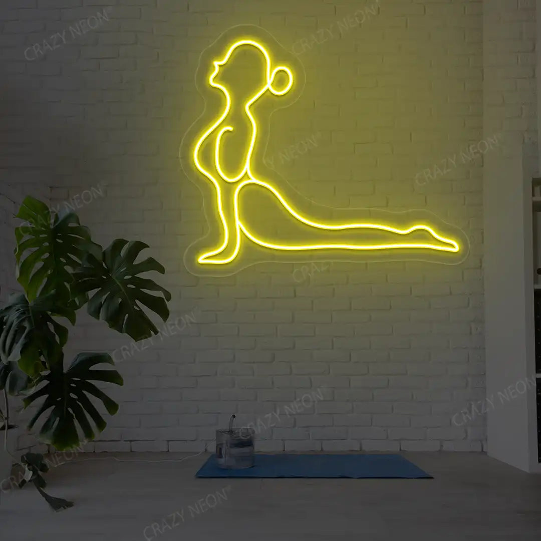 Bhujangasana Yoga Neon Sign glowing in yellow color in a yoga room