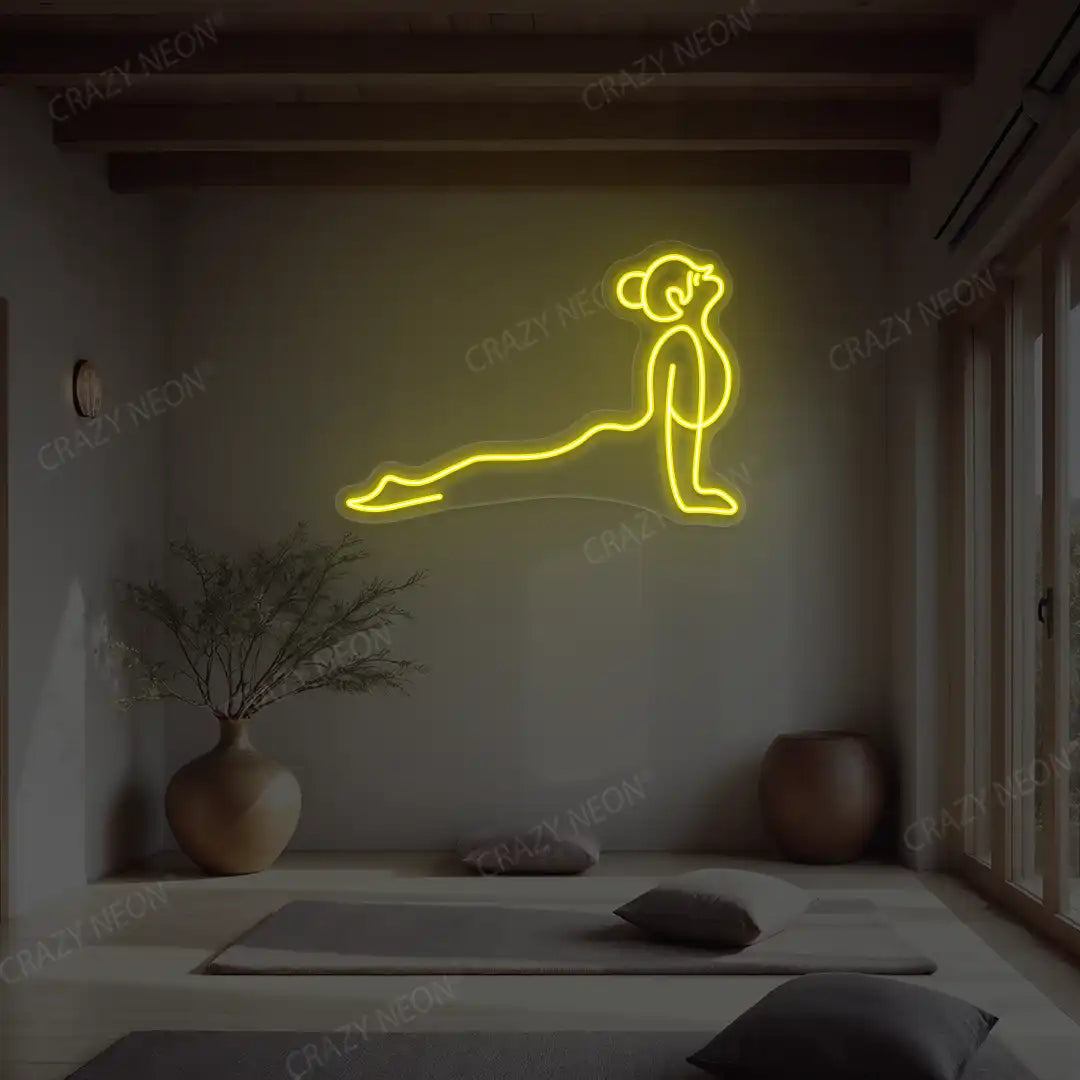 Urdhva Mukha Svanasana Yoga Neon Sign lighting up in yellow color in a yoga room