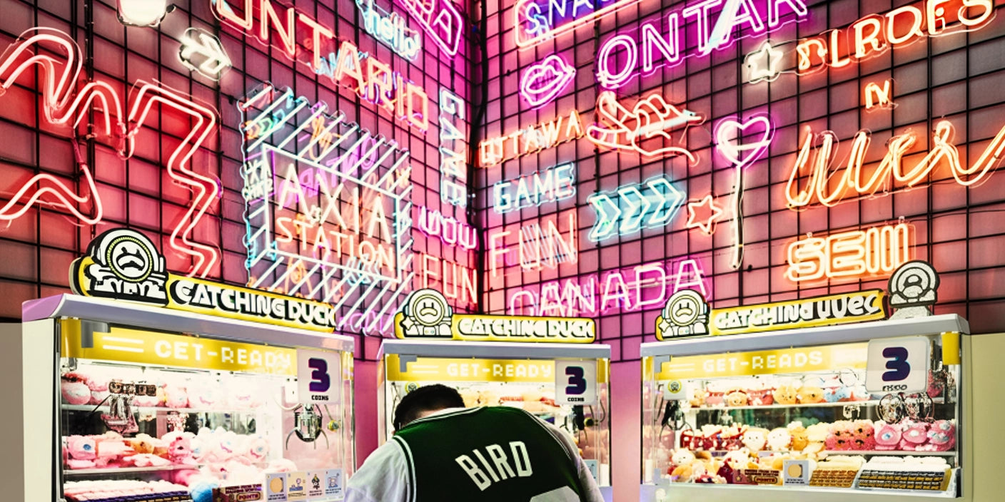 Neon gaming signs wall decor at arcade with plush claw machines