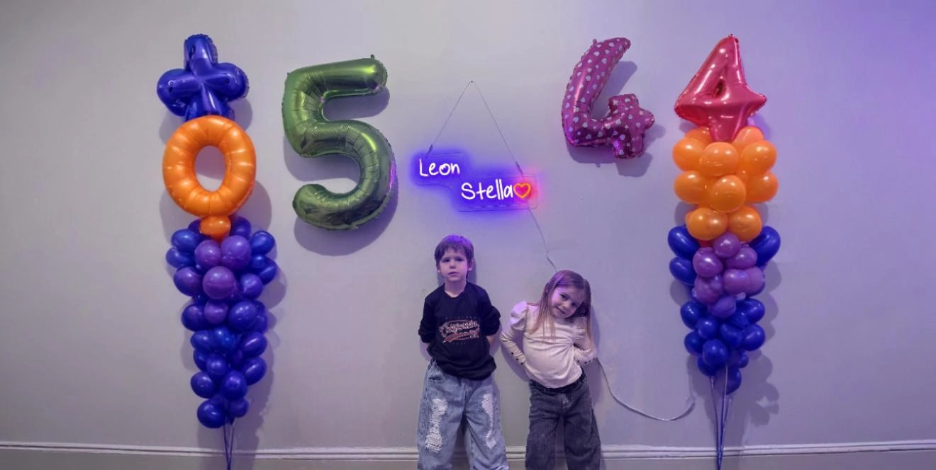 Birthday party balloons and custom neon sign with kids