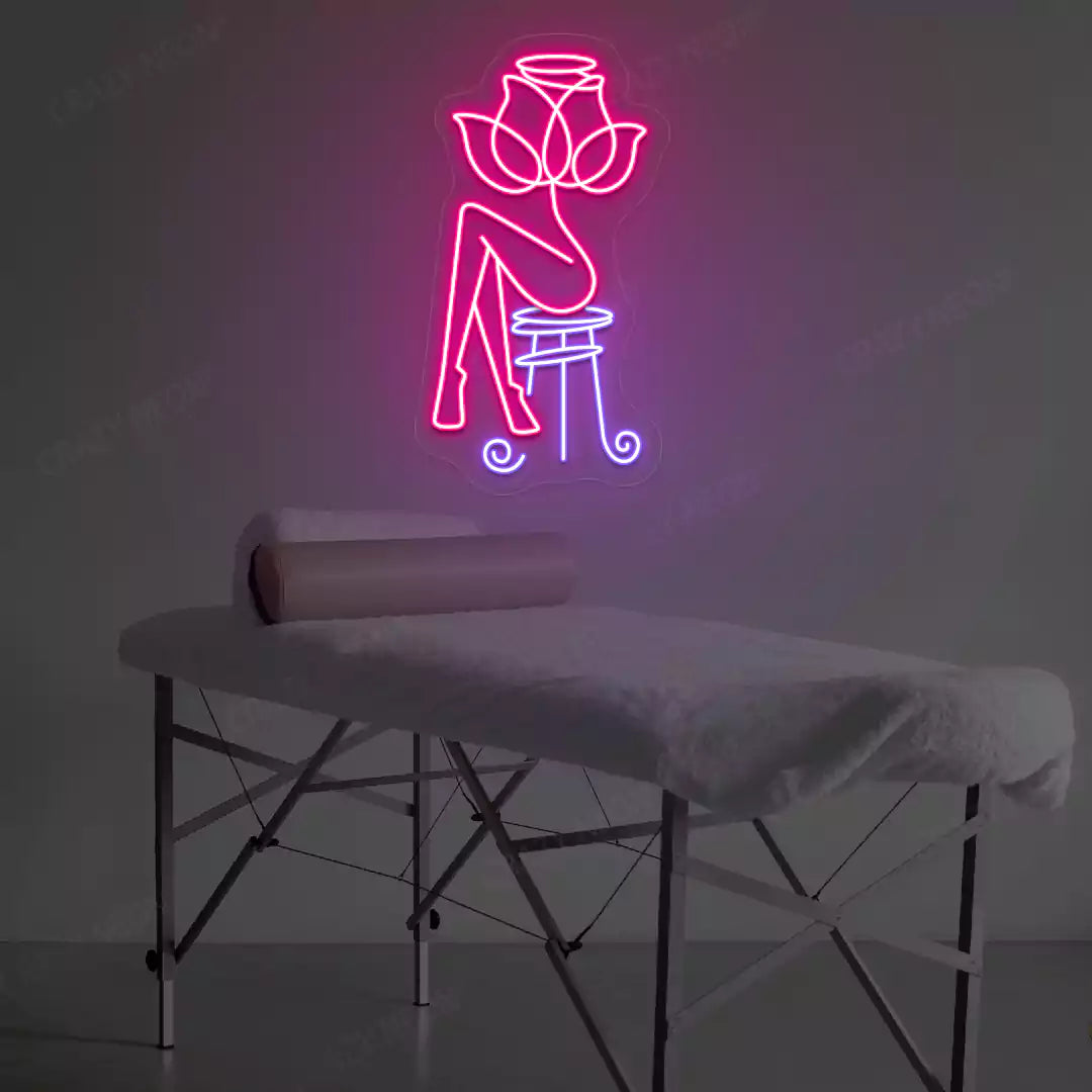 Rose Bliss Spa neon sign in pink and purple colors glowing in a spa room