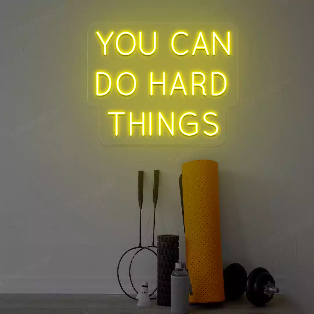 yellow you can do hard things neon sign mounted on a wall