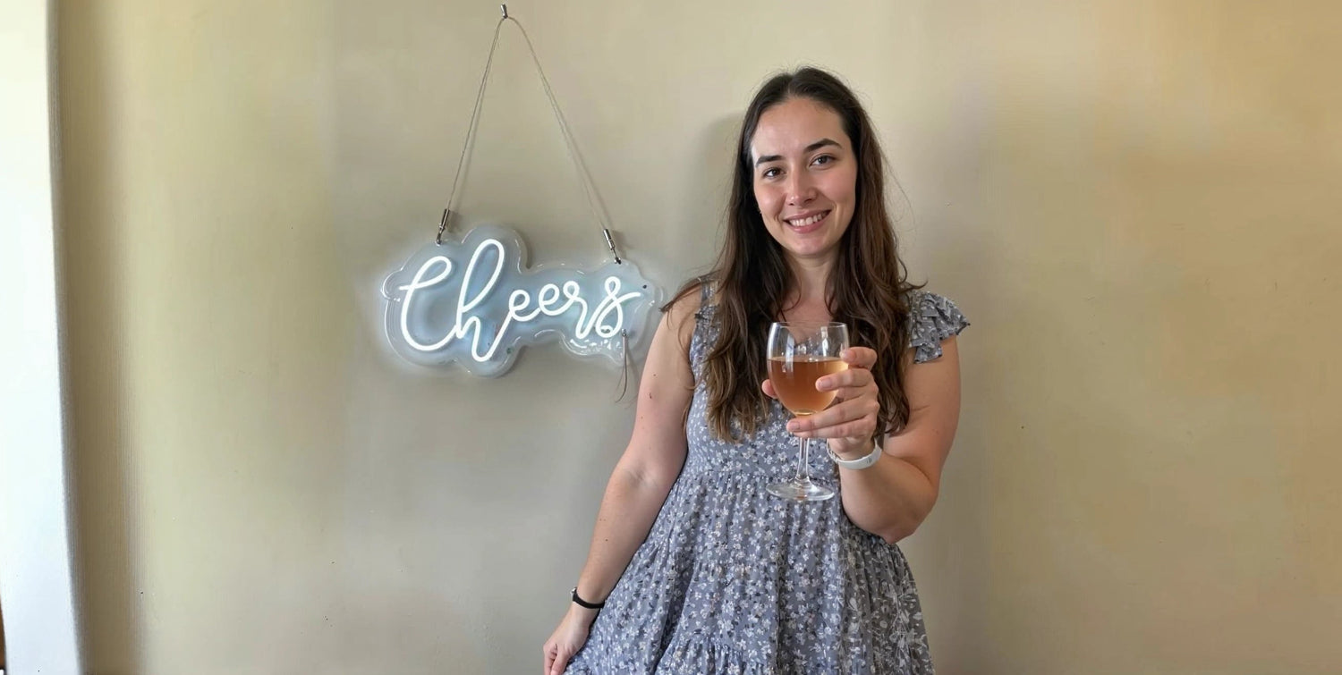 Cheers neon sign wall decor with woman holding wine glass in celebration