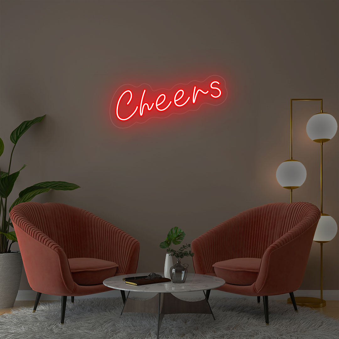 Cheers red neon sign wall decor in modern lounge with velvet chairs and gold floor lamp