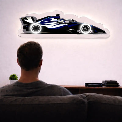 Formula race car LED wall art with illuminated wheels, creating a bold motorsport inspired focal point in a modern living room for racing enthusiasts.