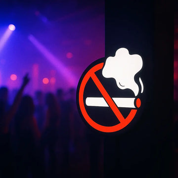 No smoking neon sign glowing in dark nightclub with colorful lights in background