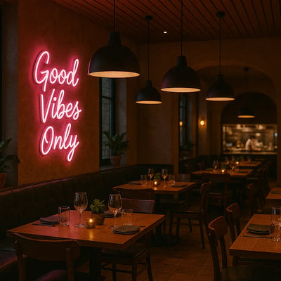 Cozy restaurant interior with pink Good Vibes Only neon sign 