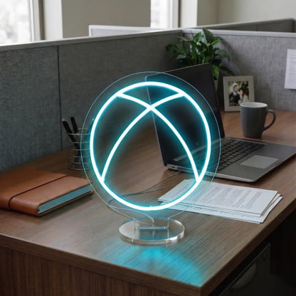 Ice Blue Xbox neon lamp on a modern office desk beside a laptop, notebook, and workspace essentials in a professional cubicle setting.