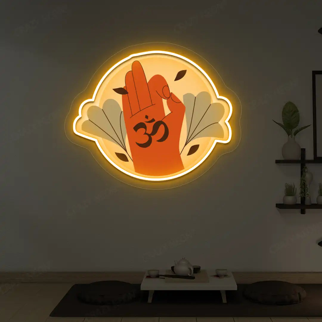 Om Gyan Mudra Neon Artwork lighting up in orange color in a yoga room