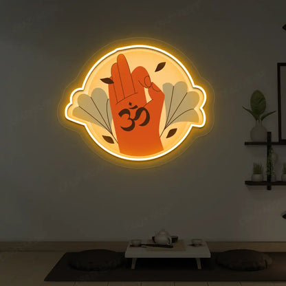 Om Gyan Mudra Neon Artwork lighting up in orange color in a yoga room