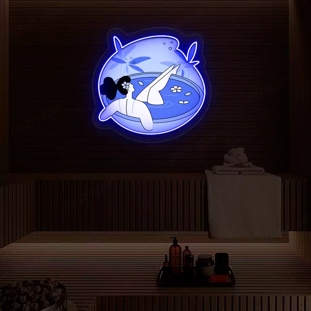 Blue Blossom Bath Neon Artwork lighting up in blue color on a wooden spa wall