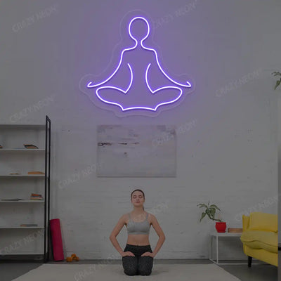 Sukhasana Yoga Neon Sign lighting up in purple color in a yoga room