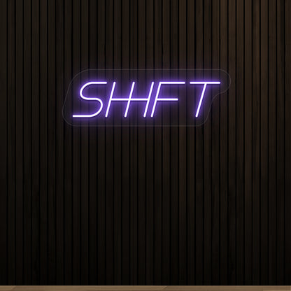 purple shift vintage neon sign mounted on a wall