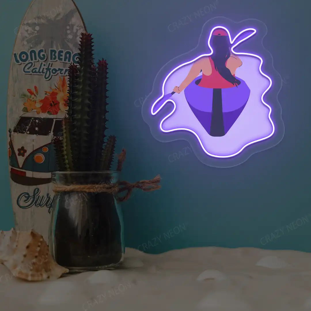 purple woman kayaking neon artwork mounted on a wall