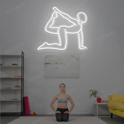 Eka Hasta Vyaghrasana Yoga Neon Sign glowing in white color in a yoga room
