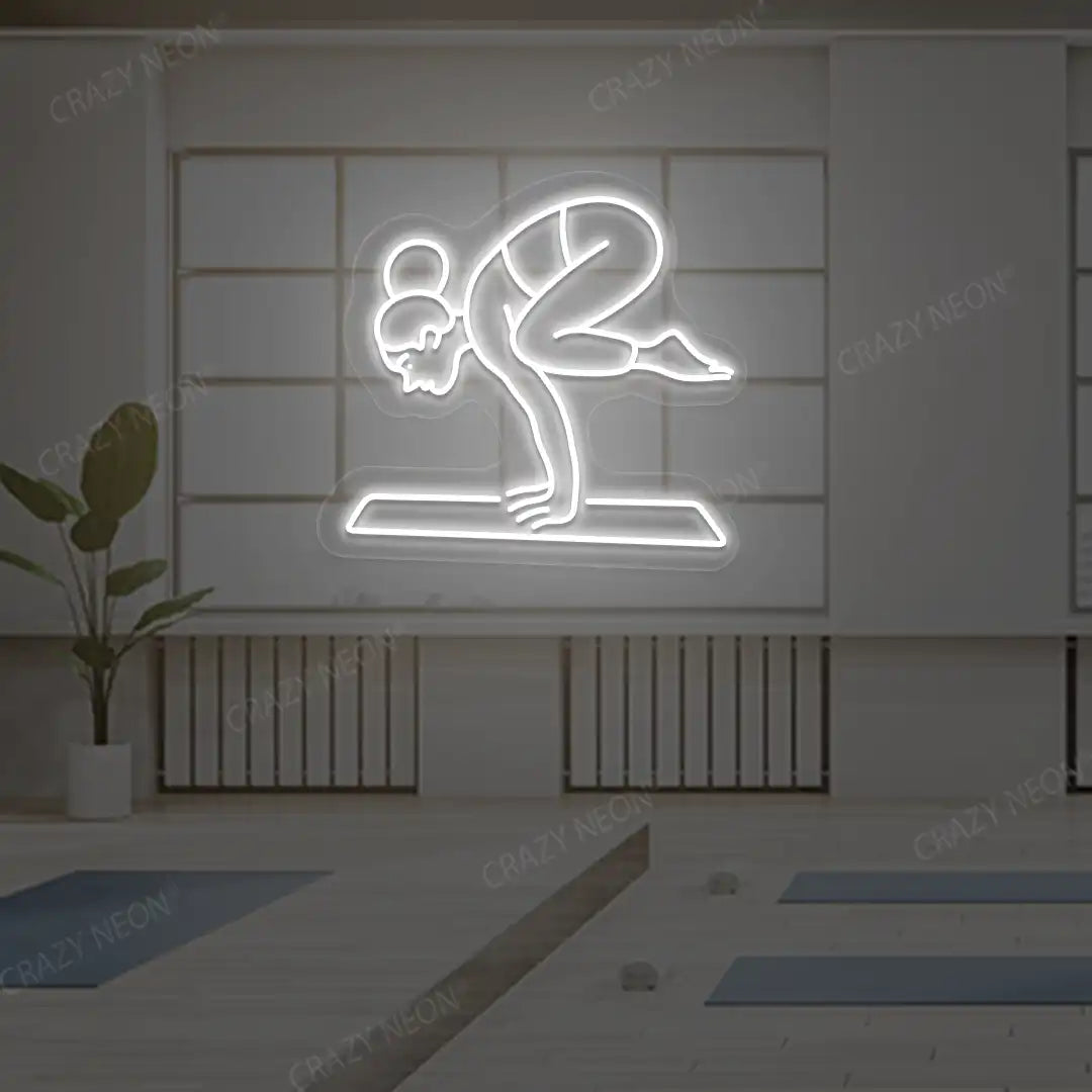Bakasana Yoga Neon Sign lighting up in white color in a yoga room