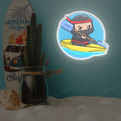 white ninja kayaking neon artwork mounted on a wall