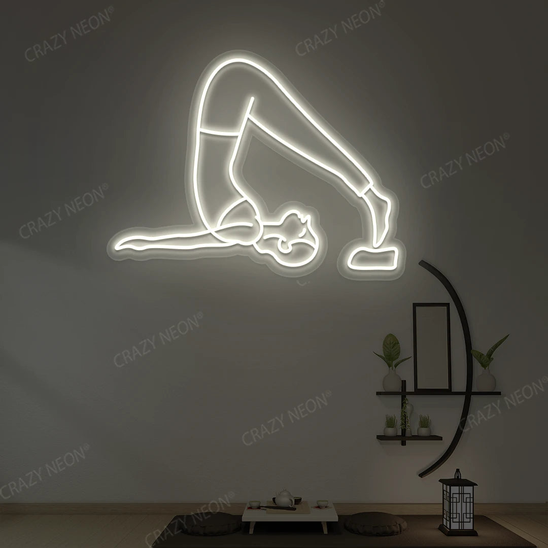 Halasana Yoga Neon Sign glowing in warm white color in a yoga room
