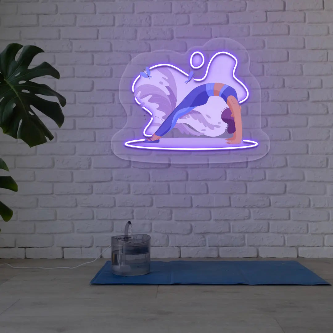 Urdhva Dhanurasana Yoga Neon Artwork lighting up in purple color in a yoga room