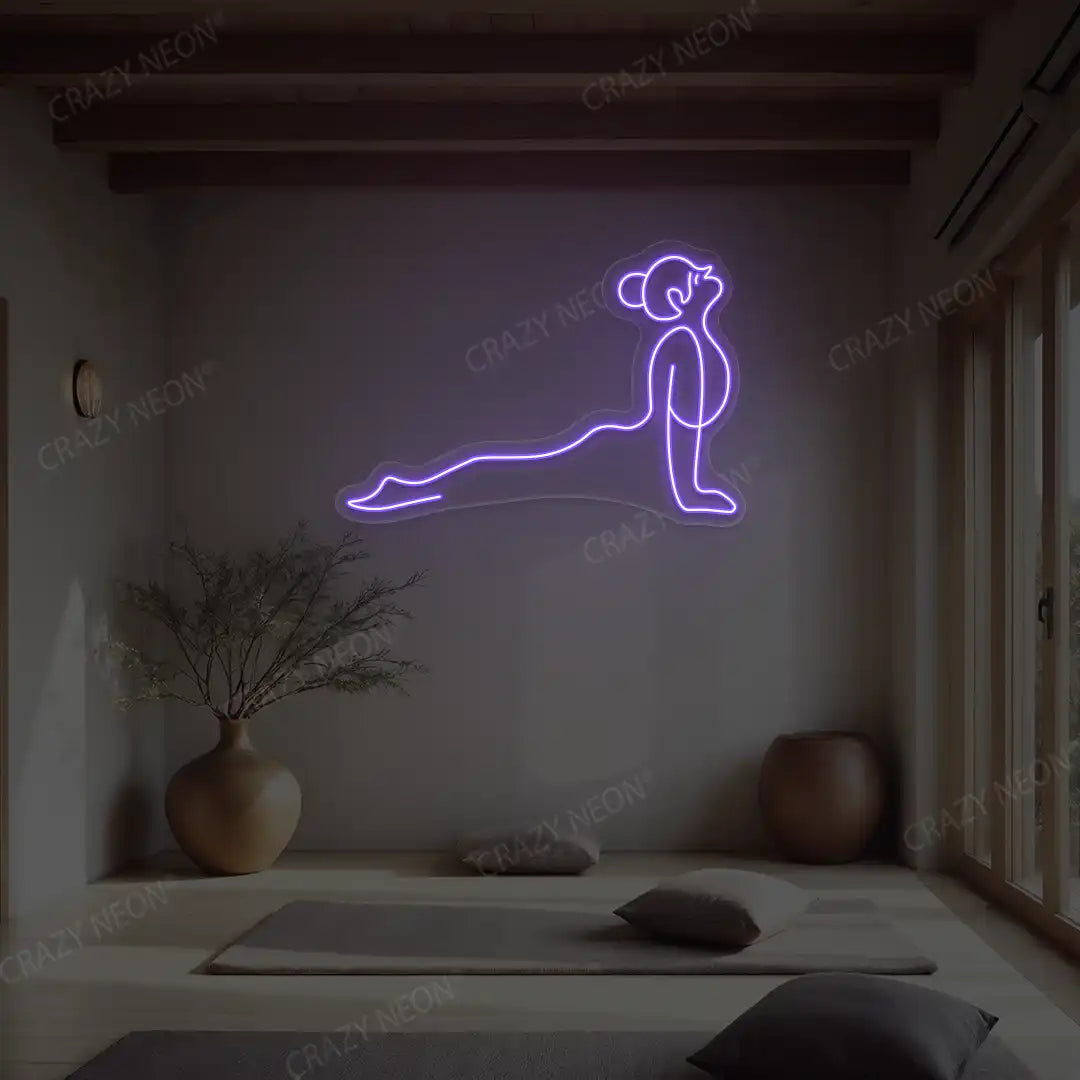 Urdhva Mukha Svanasana Yoga Neon Sign lighting up in purple color in a yoga room