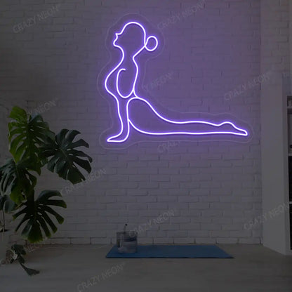 Bhujangasana Yoga Neon Sign glowing in purple color in a yoga room