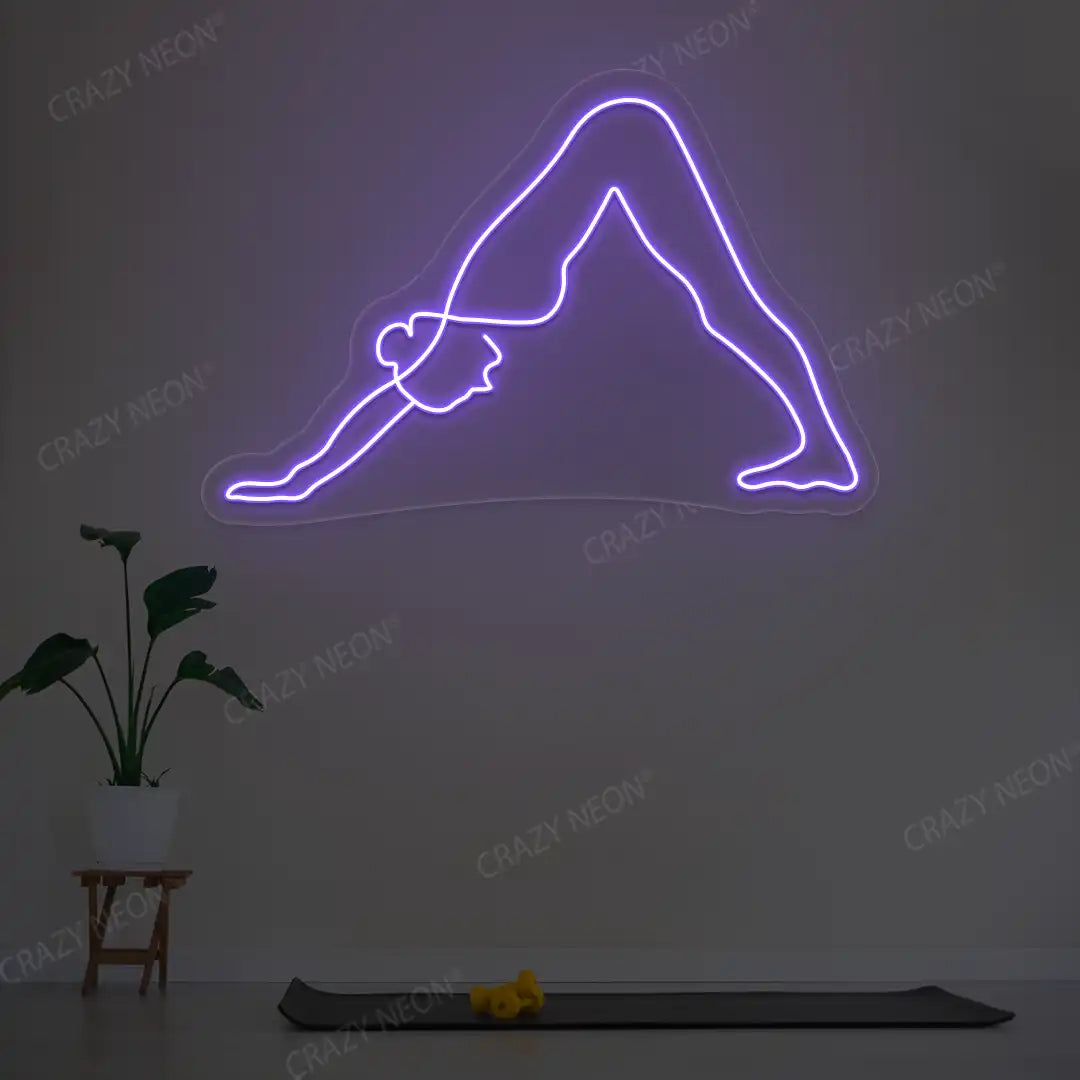 Adho Mukha Svanasana Yoga Neon Sign lighting up in purple color in a yoga room
