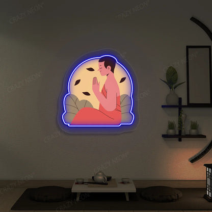 Serene Monk Neon Artwork lighting up in blue color in a yoga room