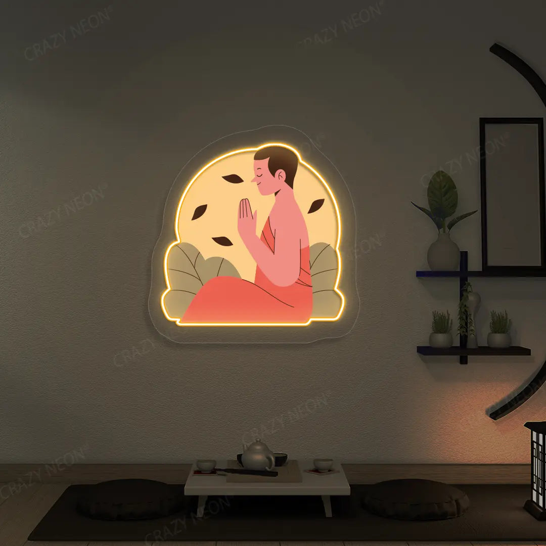 Serene Monk Neon Artwork lighting up in orange color in a yoga room