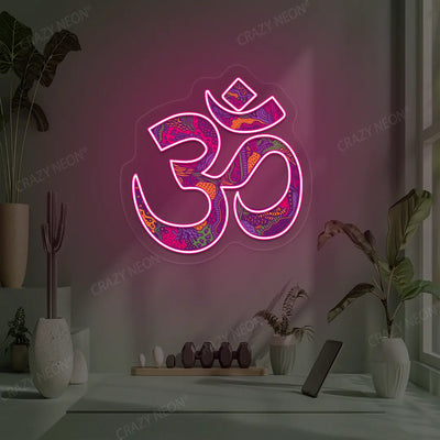 Psychedelic OM Neon Artwork lighting up in pink color in a yoga room