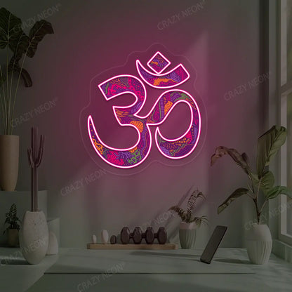 Psychedelic OM Neon Artwork lighting up in pink color in a yoga room