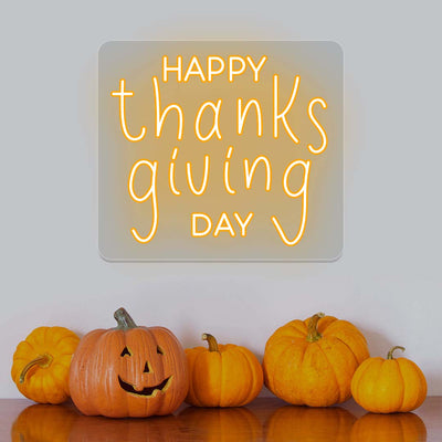Happy Thanksgiving Day neon sign in orange with pumpkins, festive wall decor for autumn holiday celebration