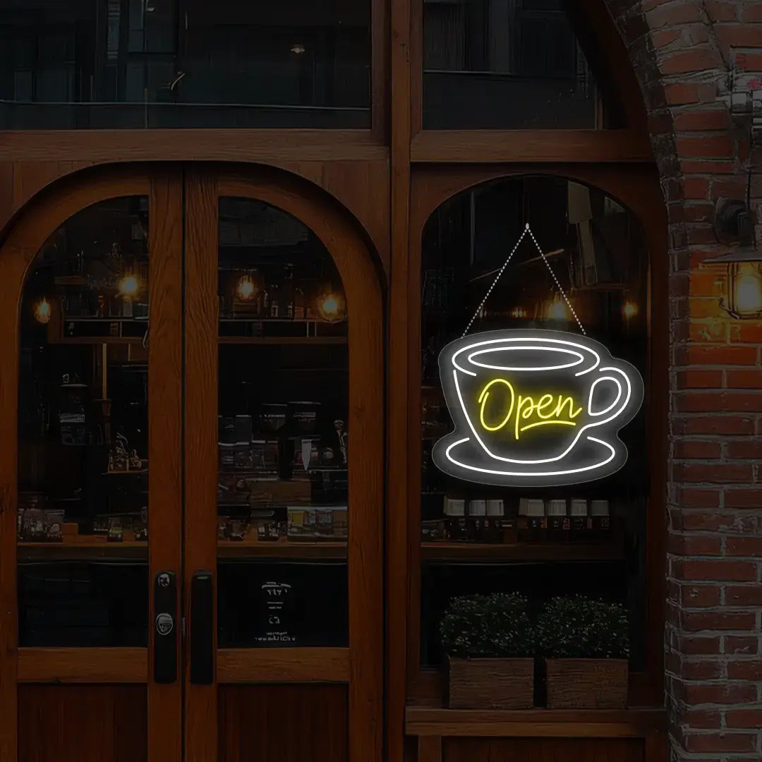 yellow coffee open neon sign hanging on a window